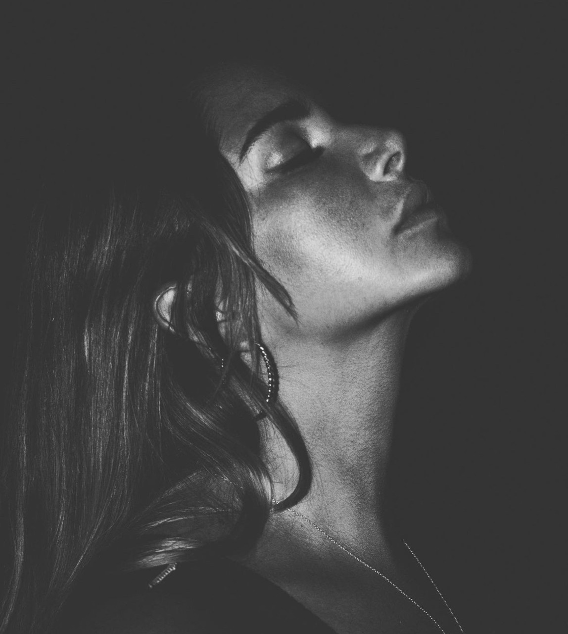 Vicentta in black and white, head tilted back, eyes closed